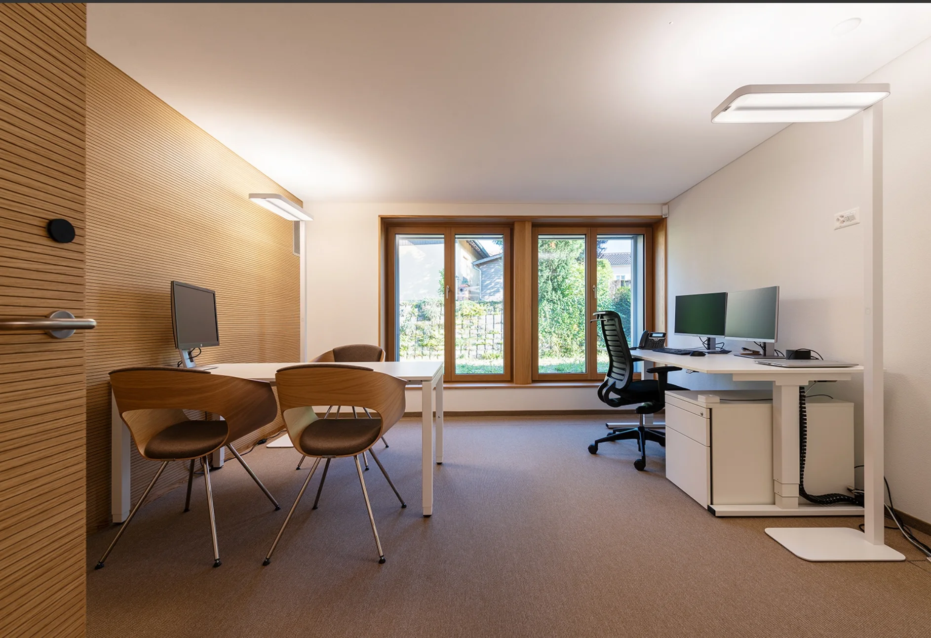 Classic grooved timber acoustic wall in a daylit office interior